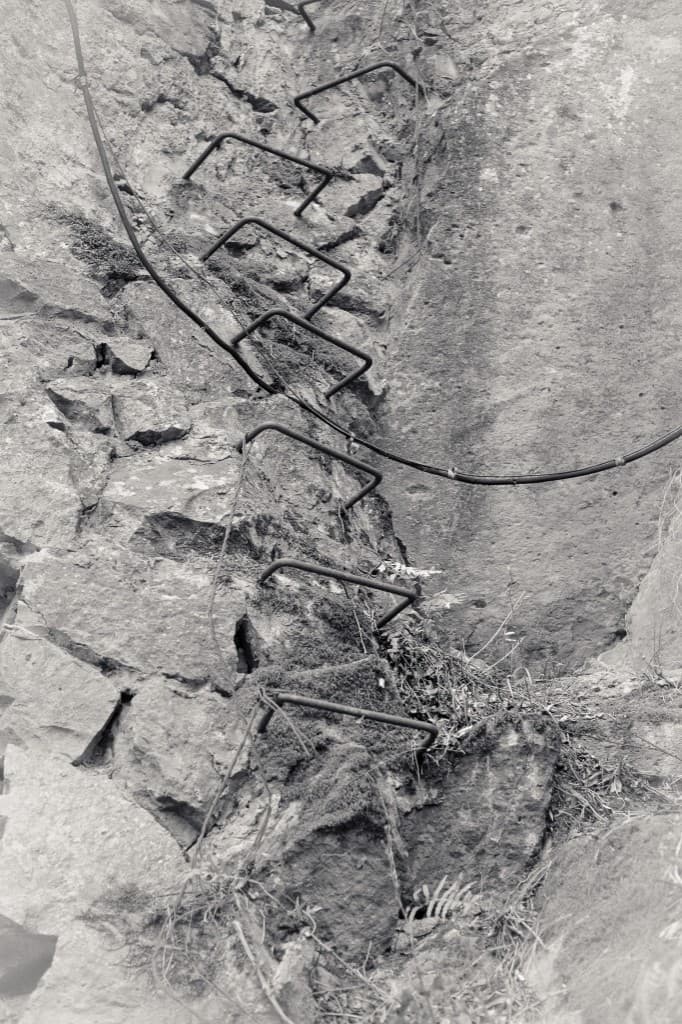 Iron rungs set into a rock face.